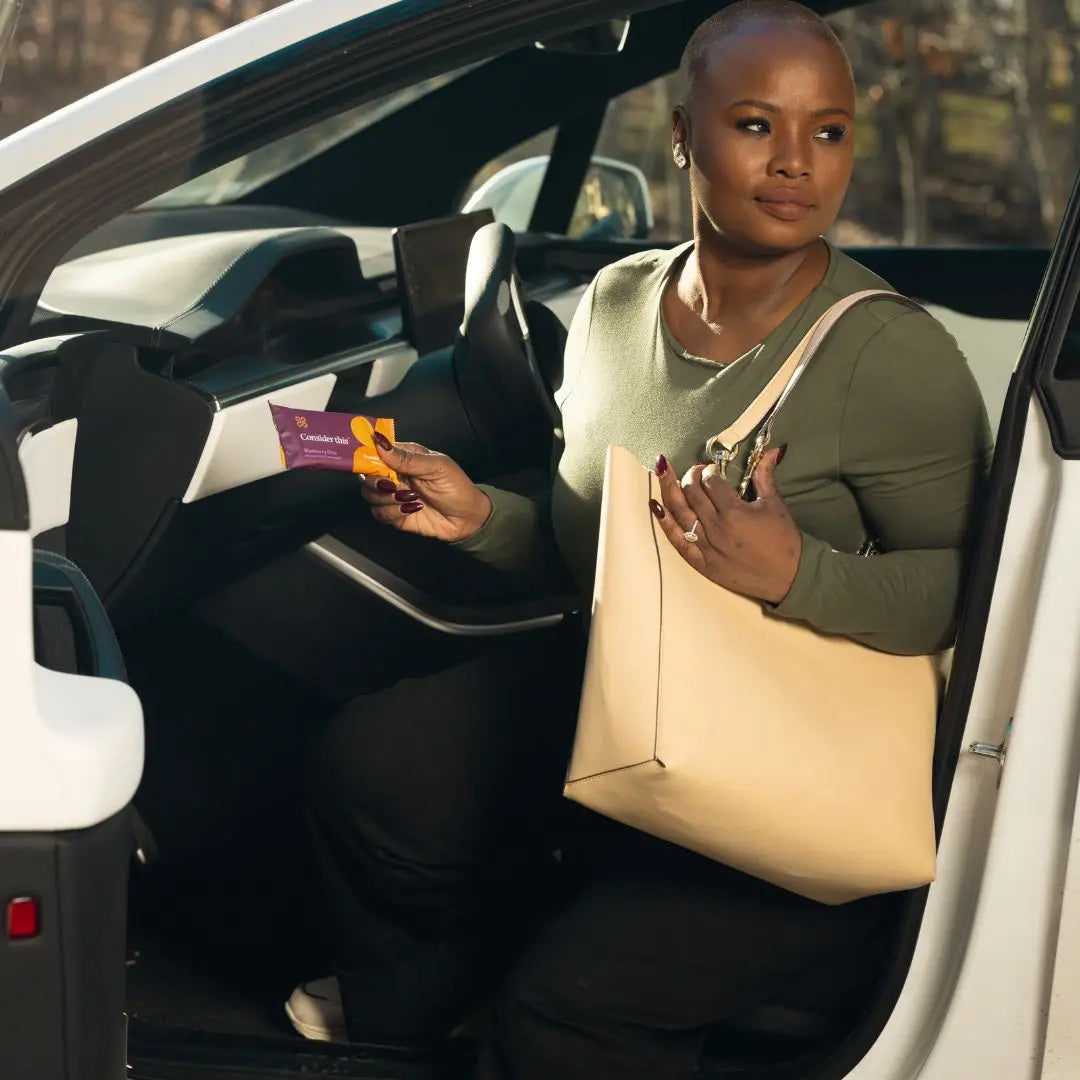 image of woman pulling a blueberry chia bar out of her bag